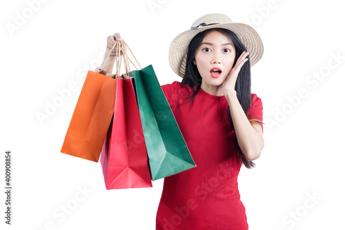 Asian woman with hat carrying shopping bags