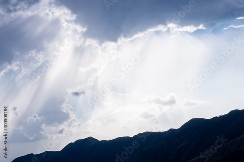 cloudy sky with white sun rays