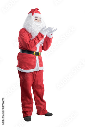 Asian man in Santa costume blow something on his hand