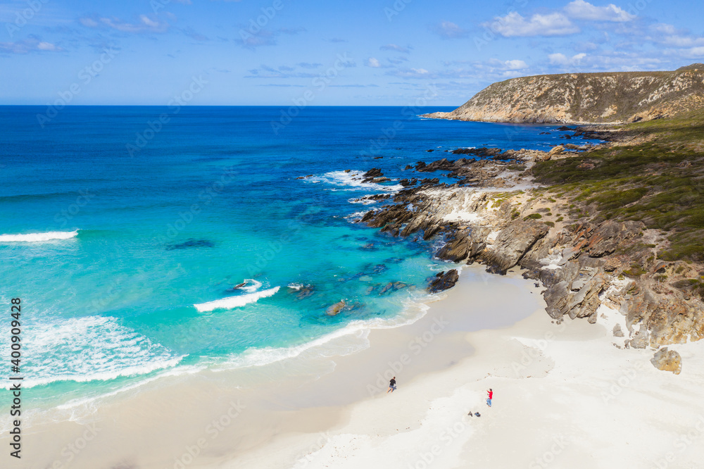 Obraz premium A lone man walking along an empty beach in the Fitzgerald River National Park. 