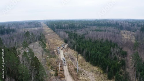 Aerial drone view flying over place where logs are stacked. photo