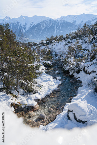 Sunny winter landscape with mountain creek in Austrian Alps, Mieming, Tyrol, Austria