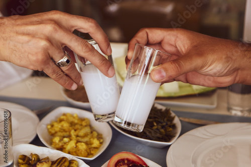 Turkish and Greek Traditional Dinning Table with Special Alcohol Drink Raki. Ouzo and Turkish Raki is a dry anise flavoured aperitif that is widely consumed in Turkey, Greece, Cyprus and Lebanon photo