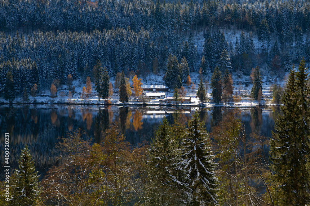 Titisee-Neustadt, Germany - 10 30 2012: surroundings of Titisee, european village, Black forest in beautiful winter cold day. Scenery is reflected in the lake. 