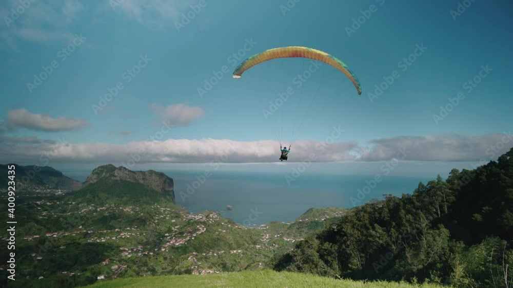 Paraglider takes off from high mountain on Madeira island, aerial Paraglider takes off from high mountain on Madeira island, aerial