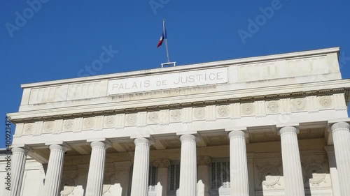 2020-12-19 Tours, France.  Courthouse of the city of Tours. (Palais de Justice de la ville de Tours in French) front view of Justice court. with french flag on top close shot with blue sky