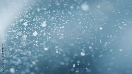 A macro shot of pieces of a soluble tablet rising to the top in bubbles.