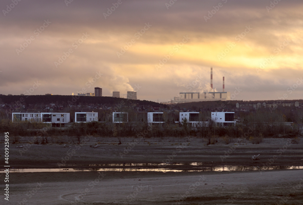 Fototapeta premium Modern houses on the sandy bank of the Ob River.