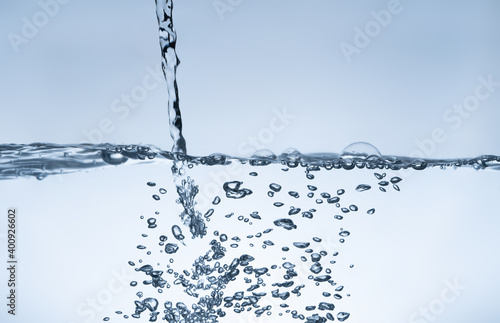 Water splash Aqua flowing in waves and creating bubbles Drops on the water surface feel fresh and clean.