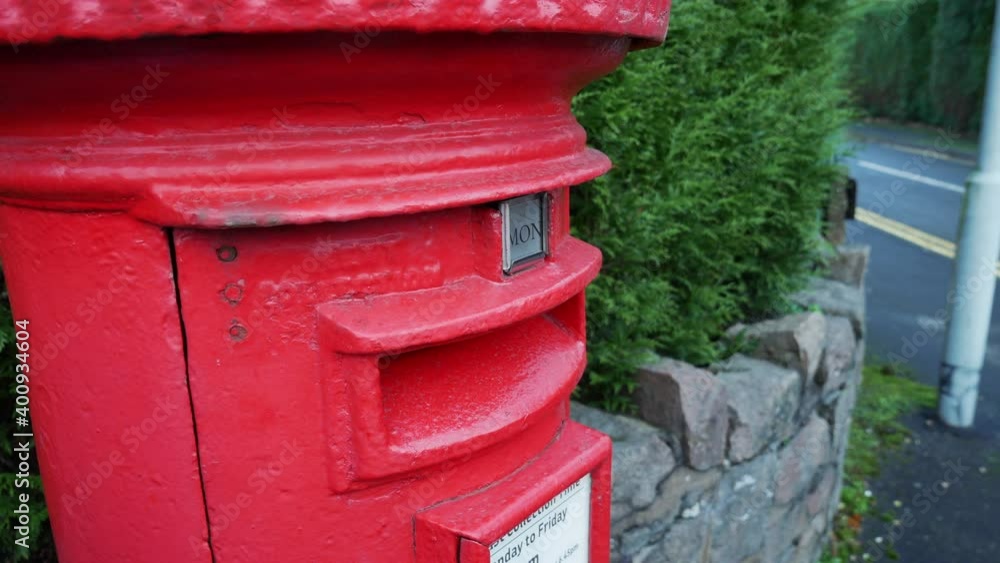 Letters are posted into a red royal mail letter post box in England. Letters are posted into a red royal mail letter post box in England.