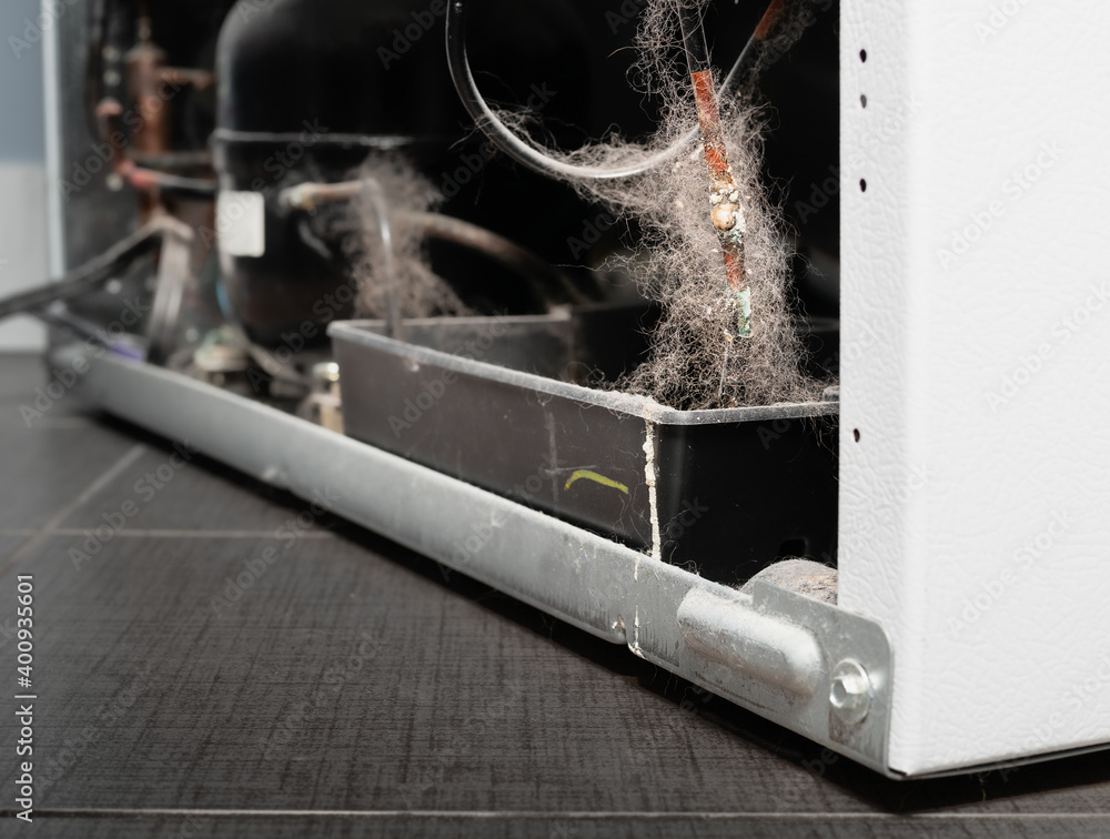 Dirty fridge copper pipe with corrosion and white efflorescence, perspective view. Backside of