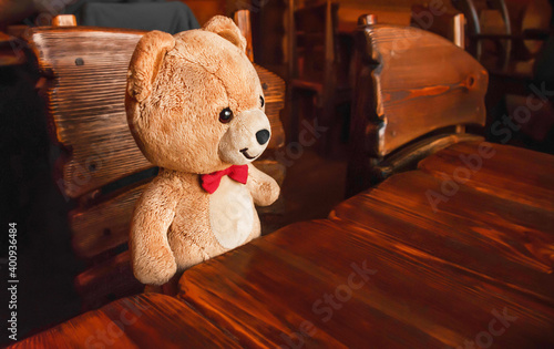 teddy bear sitting at the table. famili cafe. russian style. restaurant. Wooden furniturecopy space. brown. photo