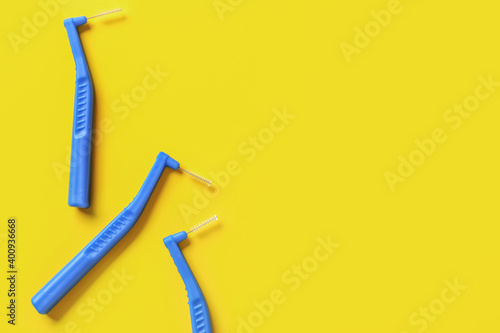 Toothbrushes for dental braces and floss on color background photo