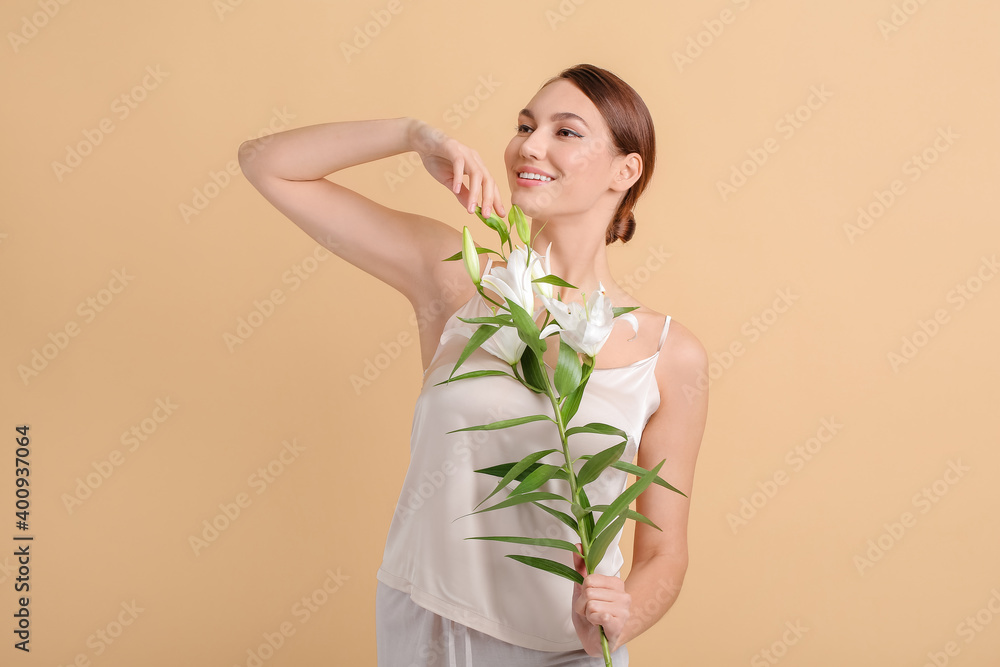 Beautiful young woman with fresh lilies on color background Beautiful young woman with fresh lilies on color background