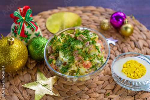 general top view, traditional russian new year and christmas olivier salad decorated with parsley, new year and christmas celebration in thailand, vegetarian and vegan egg