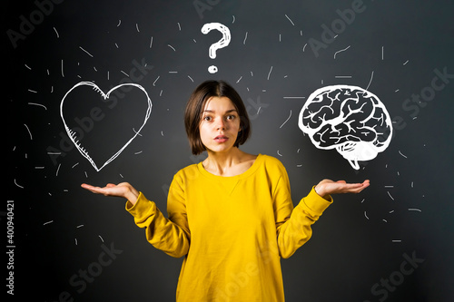 Brain or heart? A young girl is puzzled by the choice between a rational logical decision and an irrational emotional one