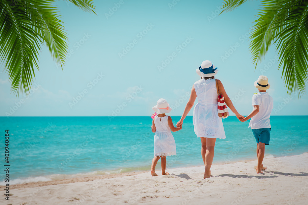 mother with son and daughter on beach