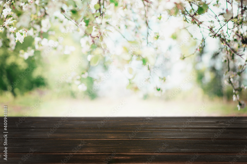 Wood table top on blur abstract green from garden in the morning background.For montage product display or design key visual layout Wood table top on blur abstract green from garden in the morning background.For montage product display or design key visual layout
