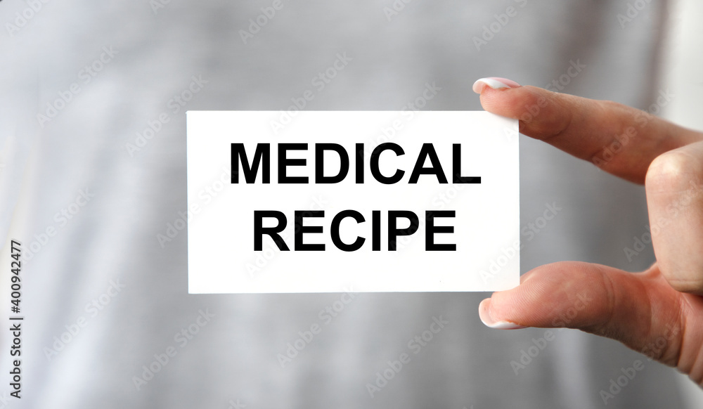 The girl holds a face with the text MEDICAL RECIPE in front of her. The girl holds a face with the text MEDICAL RECIPE in front of her.