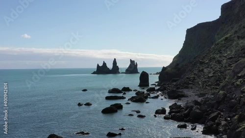 High definition drone aerial video flying over volcanic rock formations along  Atlantic Ocean Coastline near Vik, Iceland.