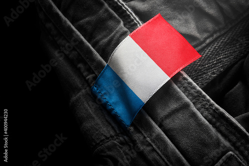 Tag on dark clothing in the form of the flag of the France