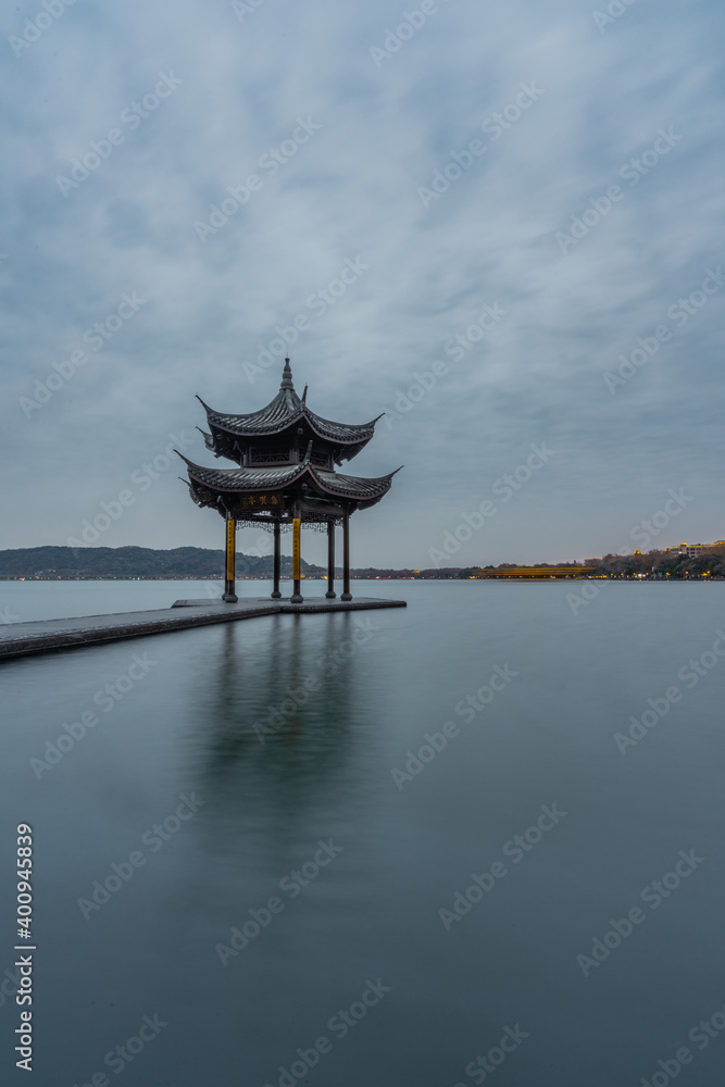 Sunset view of Jixian pavilion, the landmark at the west lake in Hangzhou, China.