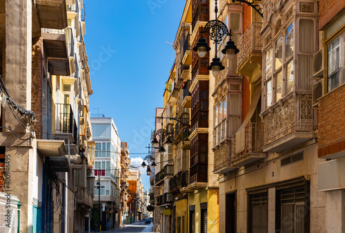 Picturesque architecture of typical narrow street in historic center of Spanish city of Cartagena on summer day