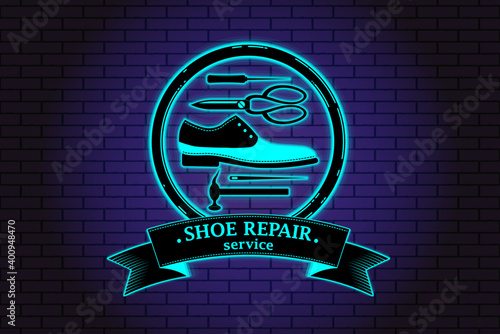 Shoe repair service. Neon symbol in old retro style. On background of brick illuminated wall