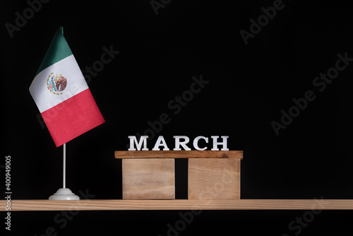 Wooden calendar of March with Mexico flag on black background. Holidays of Mexico in March