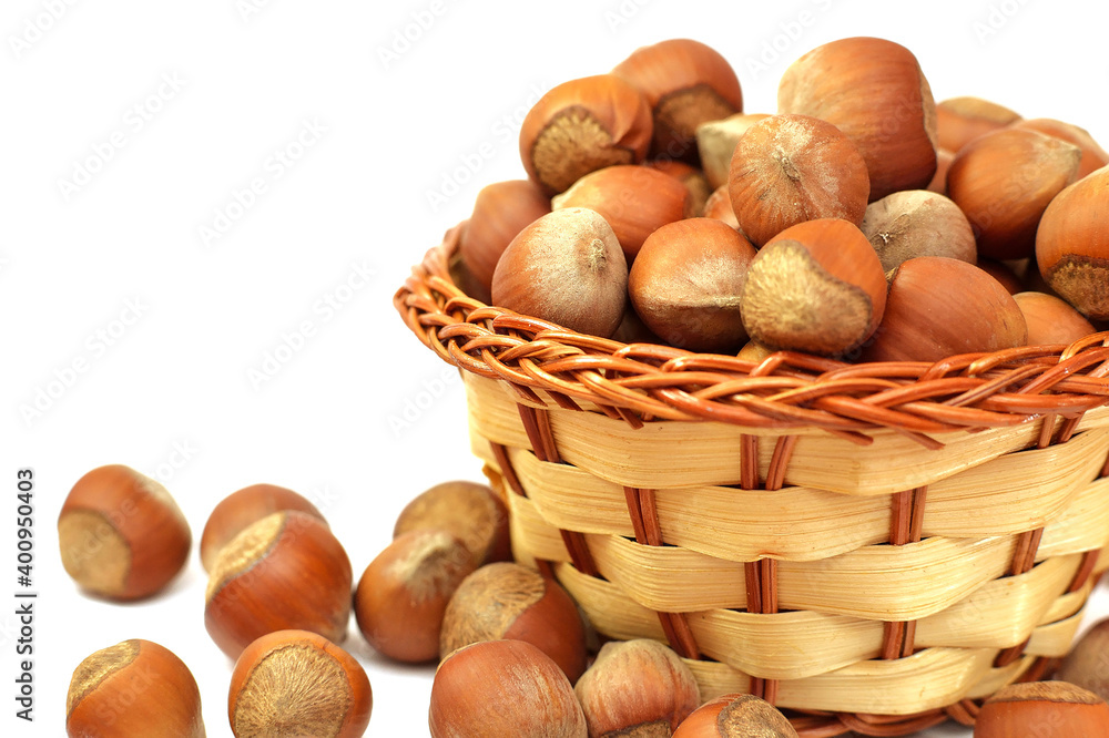 hazelnut in wicker basket isolated on white background. hazelnut in wicker basket isolated on white background.