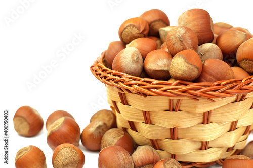 hazelnut in wicker basket isolated on white background.