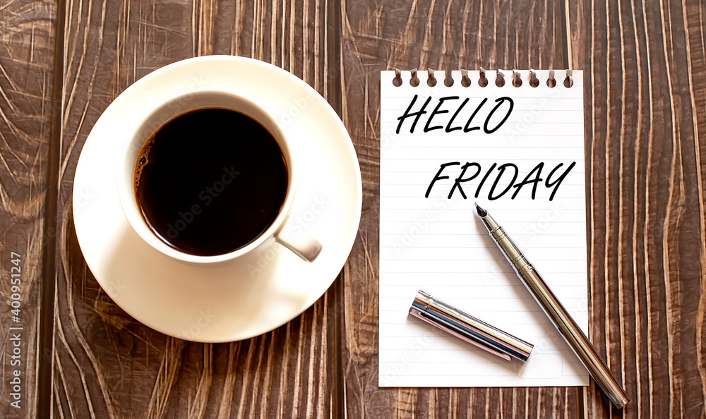 HELLO FRIDAY - white paper with pen and coffee on wooden background HELLO FRIDAY - white paper with pen and coffee on wooden background