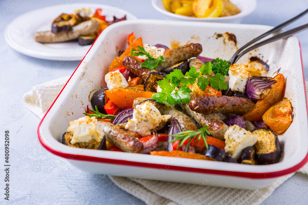 Roasted sausages with vegetables and feta cheese Roasted sausages with vegetables and feta cheese