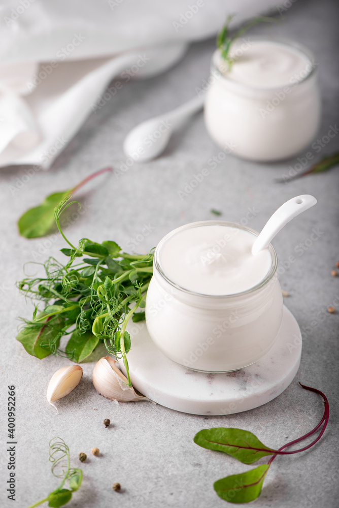 fresh greek yogurt with herbs and spices in glass jars fresh greek yogurt with herbs and spices in glass jars