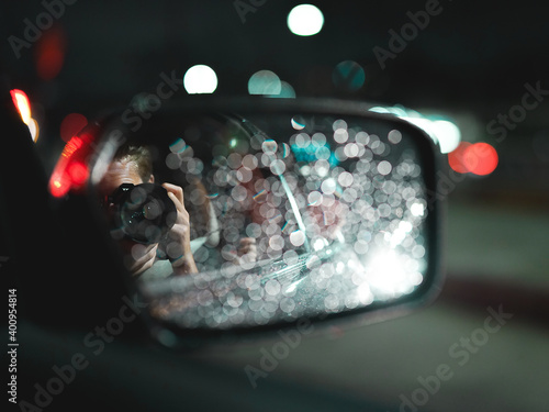 Man shoots photo of rainy night out the window of a car