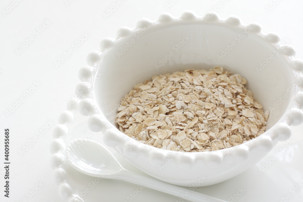 Healthy food ingredient, oatmeal in white bowl with copy space
Healthy food ingredient, oatmeal in white bowl with copy space