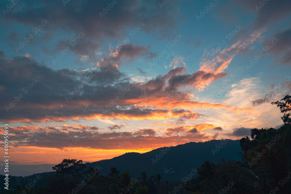 Panorama of a forest valley with mountains at colorful sunset. View from the balcony.