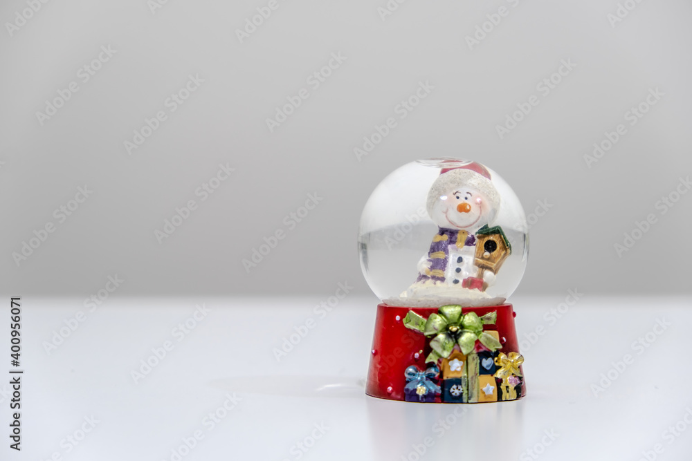 Red snow globe object. Close-up snow globe. It is a symbol of Christmas and winter. Banner concept for new year and celebration. Red snow globe object. Close-up snow globe. It is a symbol of Christmas and winter. Banner concept for new year and celebration.