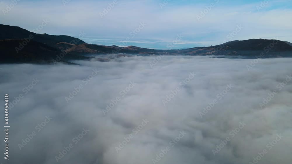 Flying through the clouds above mountain tops. High peaks wonderful morning sunrise natural Landscape Flying through the clouds above mountain tops. High peaks wonderful morning sunrise natural Landscape