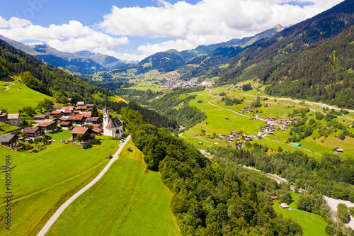 Scenic aerial view of small village of Cavardiras in Swiss Alps valley in summer, canton of Graubunden