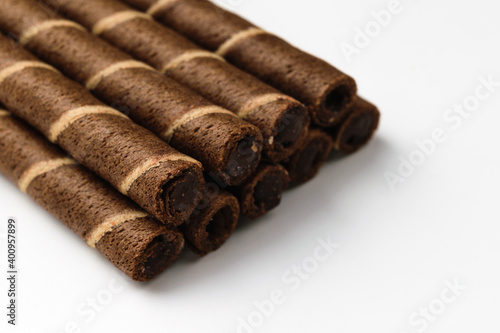 Chocolate wafer rolls on a white background