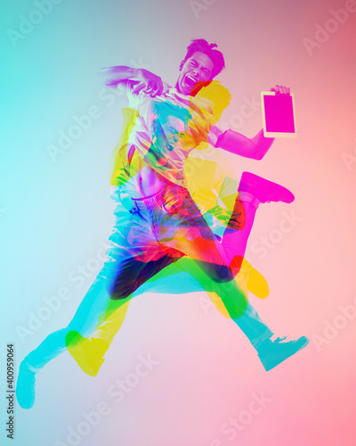 Fototapeta Naklejka Na Ścianę i Meble -  Jumping high. Multiple portrait with glitch duotone effect. Multiple exposure, abstract fashionable beauty photo. Young beautiful male model posing. Youth culture, composite image, fashionable people.