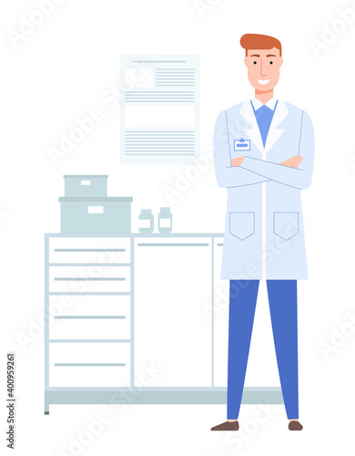 Doctor in a white coat with a badge works in the lab. Redhead therapist in medical office. Male character smiles and standes with folded arms on his chest. Working day and pastime in medical facility