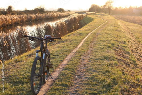 A bicycle by the river bank in the venetian countryside