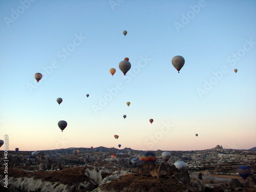 The unsurpassed beauty of an infinite number of balloons rising above the valley into the morning sky illuminated by the colors of the sunrise. © Hennadii