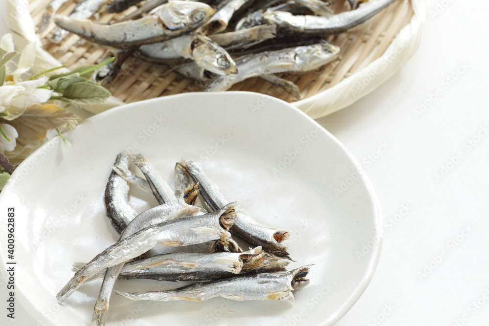 Japanese food ingredient, dried small sardines on bamboo basket for broth cooking Japanese food ingredient, dried small sardines on bamboo basket for broth cooking