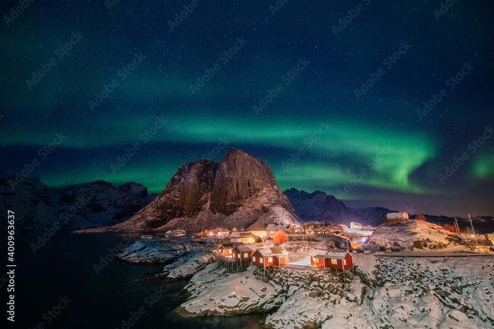 custom made wallpaper toronto digitalAurora borealis on the Hamnoy village in Lofoten islands, Norway. Green northern lights above mountains. Night sky with polar lights. Night winter landscape.