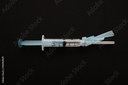 View of syringe closeup on black background