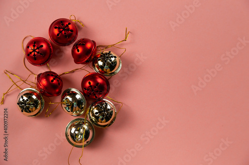 Top view of Christmas bells with many candy cane on pastel pink background.Holiday festive celebration greeting card with copy space to addng text photo