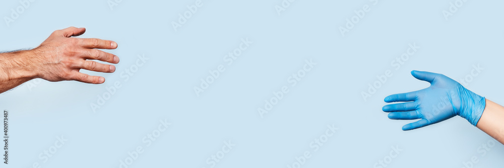 Picture in blue and yellow tones. Banner with men hand and the woman hand in the latex glove are drawn to each other. Picture in blue and yellow tones. Banner with men hand and the woman hand in the latex glove are drawn to each other.